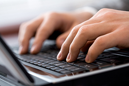 Arbeitsplatz/Laptop/Tastatur/Schreiben/Tippen/Hände/Finger